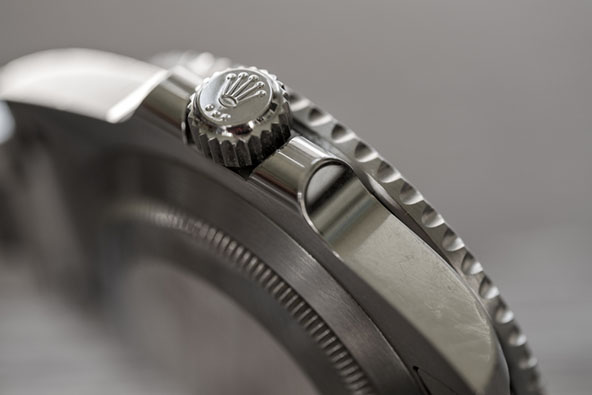 Close-up, shallow focus image of a famous, Swiss manufactured men's diving watch showing detail