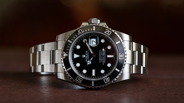 Rolex Submariner watch close up against black background