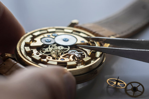 Watchmaker repairs mechanical watch