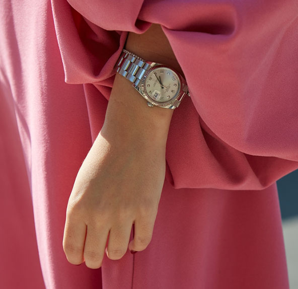 Woman with silver Rolex