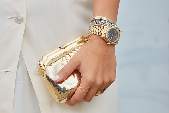 woman with yellow gold watch