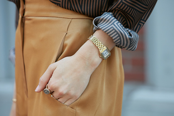 woman with yellow gold watch